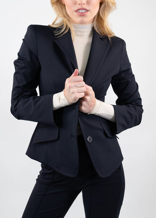 Woman wearing a black blazer and black pants on a white background