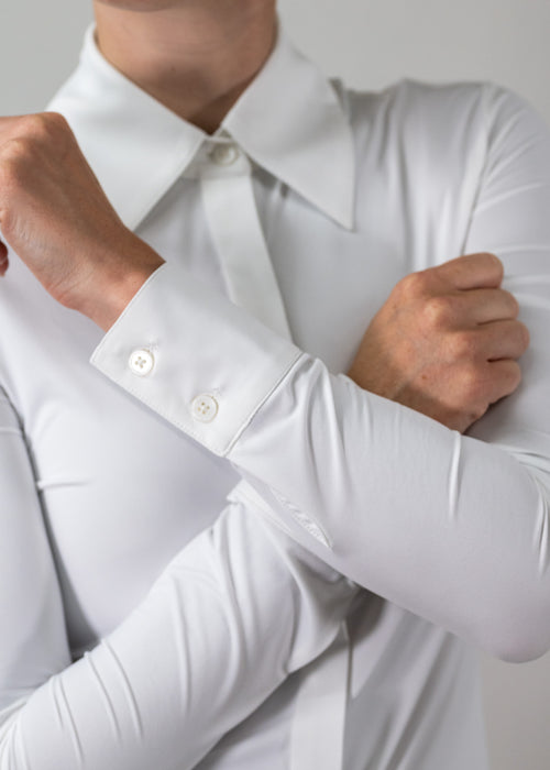 Close-up of a person wearing a white dress shirt